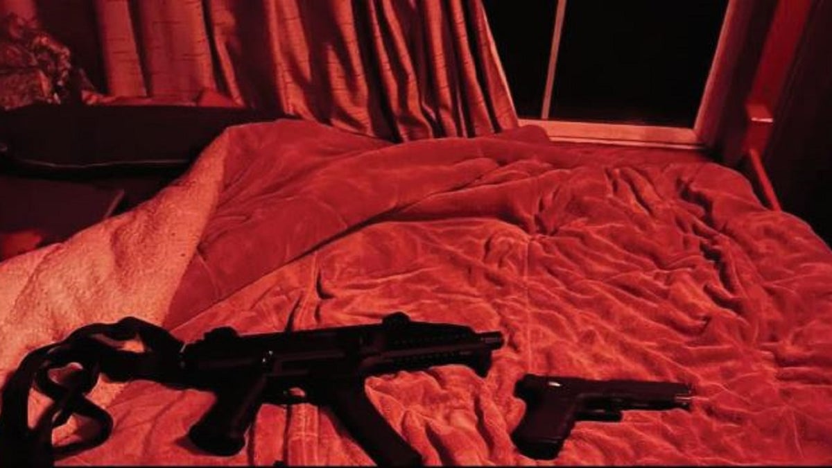 Two firearms on a bed