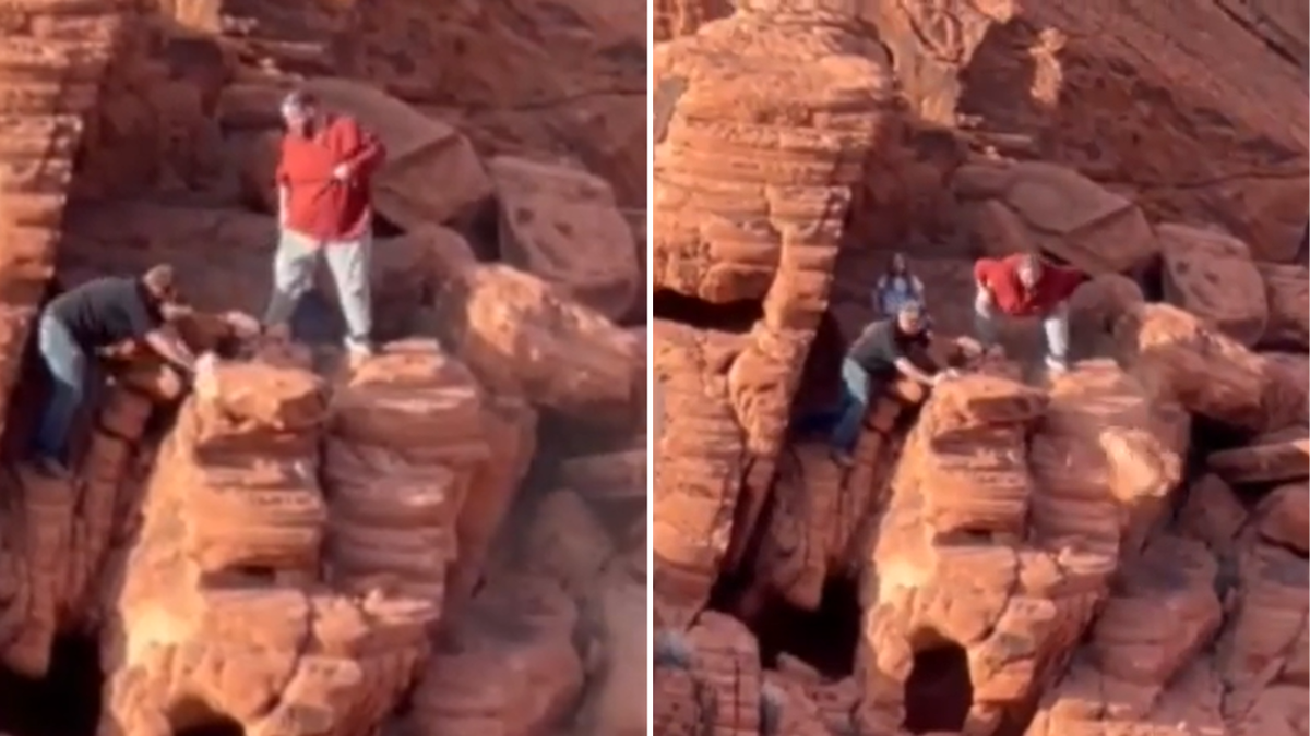 Men seen traversing rocks to push down ancient stones