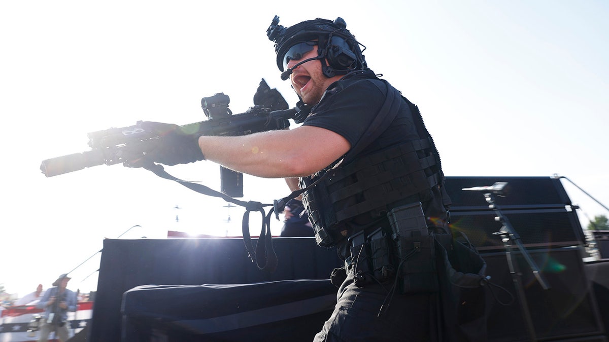 A law enforcement officer moves during republican presidential candidate former President Donald Trump's rally