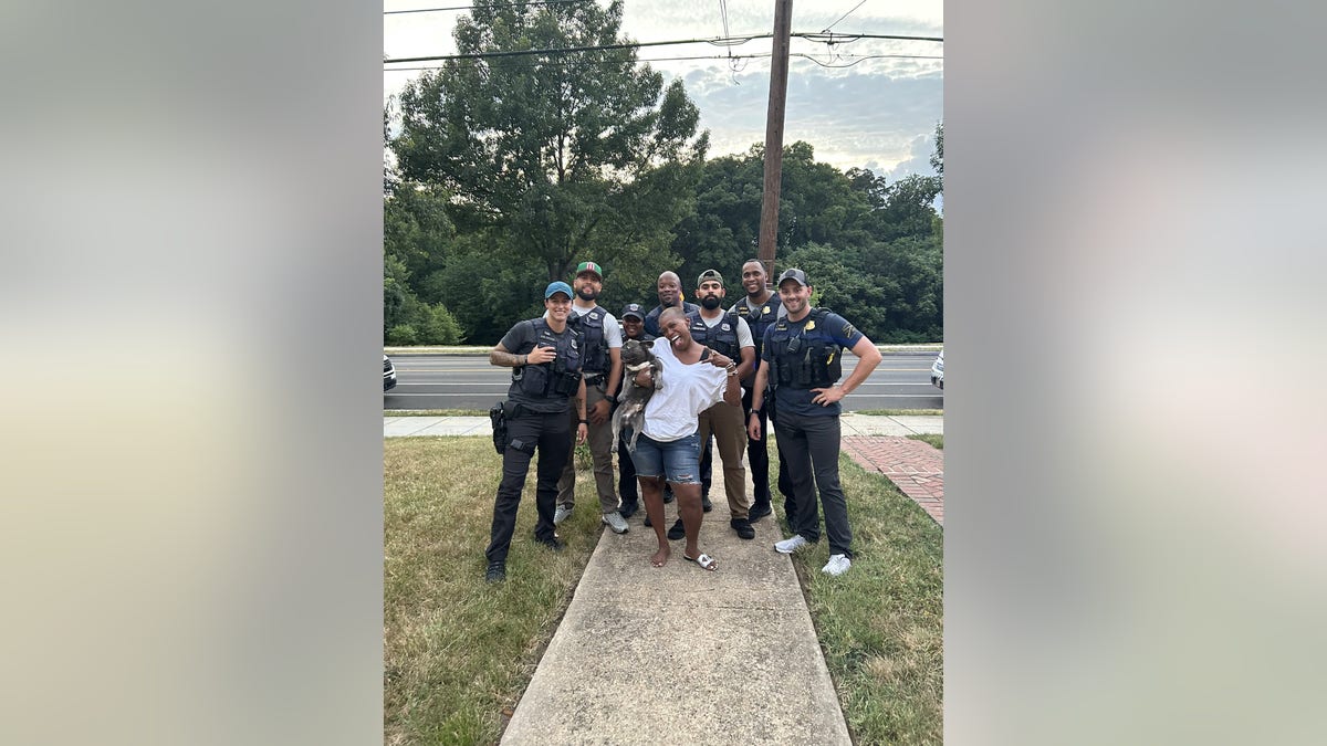 Members of MPD’s Violent Crimes Suppression Division and 'Yurman' back with his owner. 