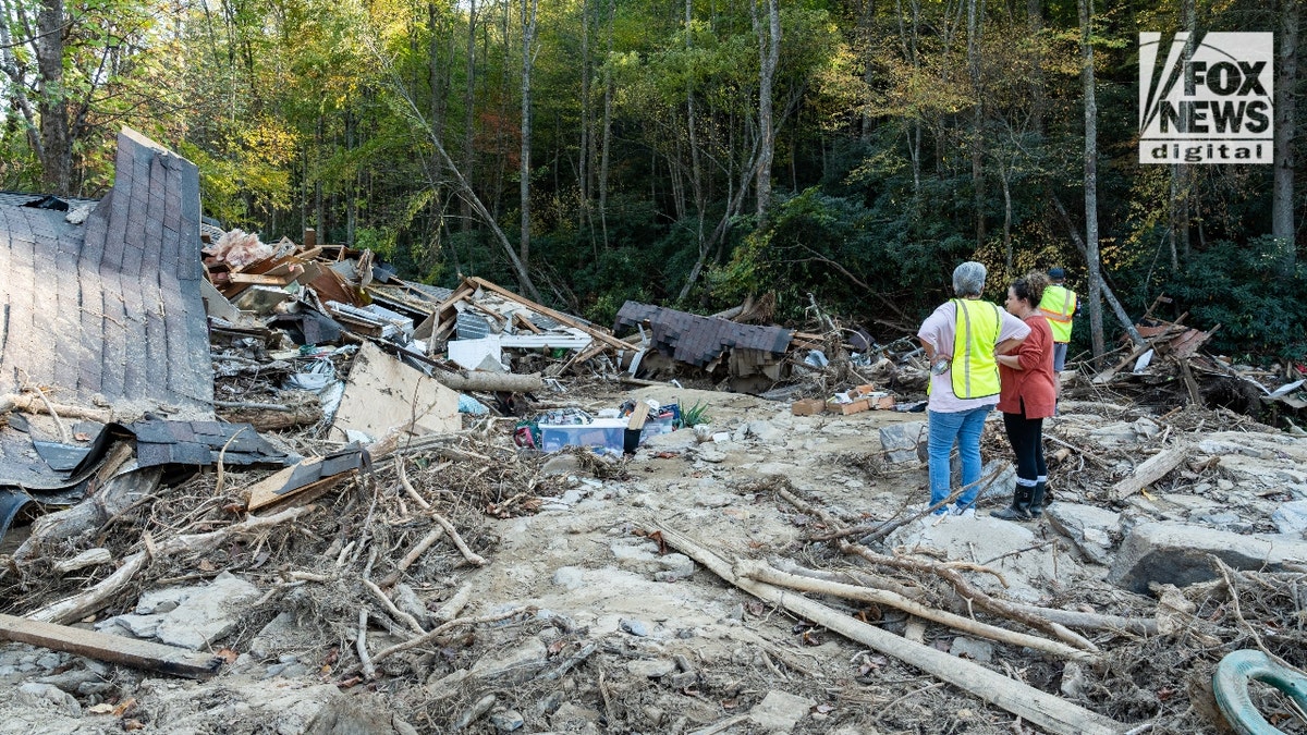 Mekenzie Craig stands outside her in-laws' destroyed home