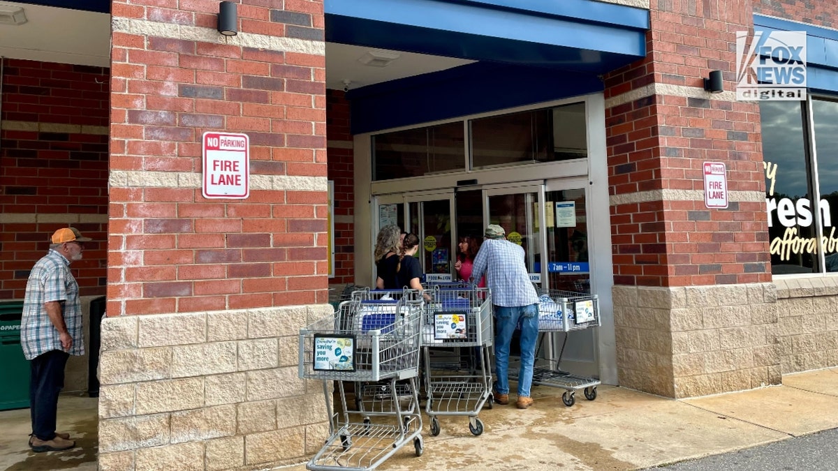 A Food Lion in Fairview, North Carolina, hands out bags of ice.