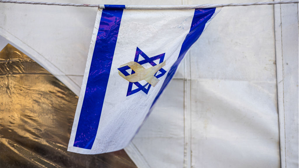 The Israeli flag with the yellow ribbon symbolizing solidarity with abductees