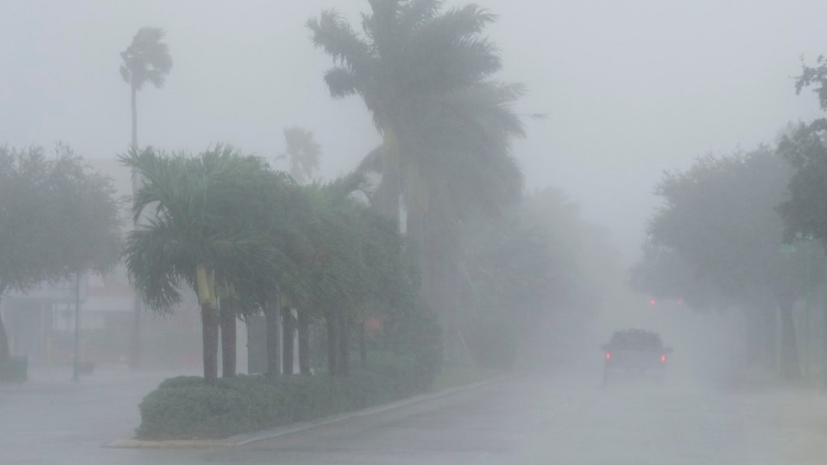 A Lee County Sheriff's officer patrols the streets of Cape Coral, Fla., as heavy rain falls ahead of Hurricane Milton, Wednesday.