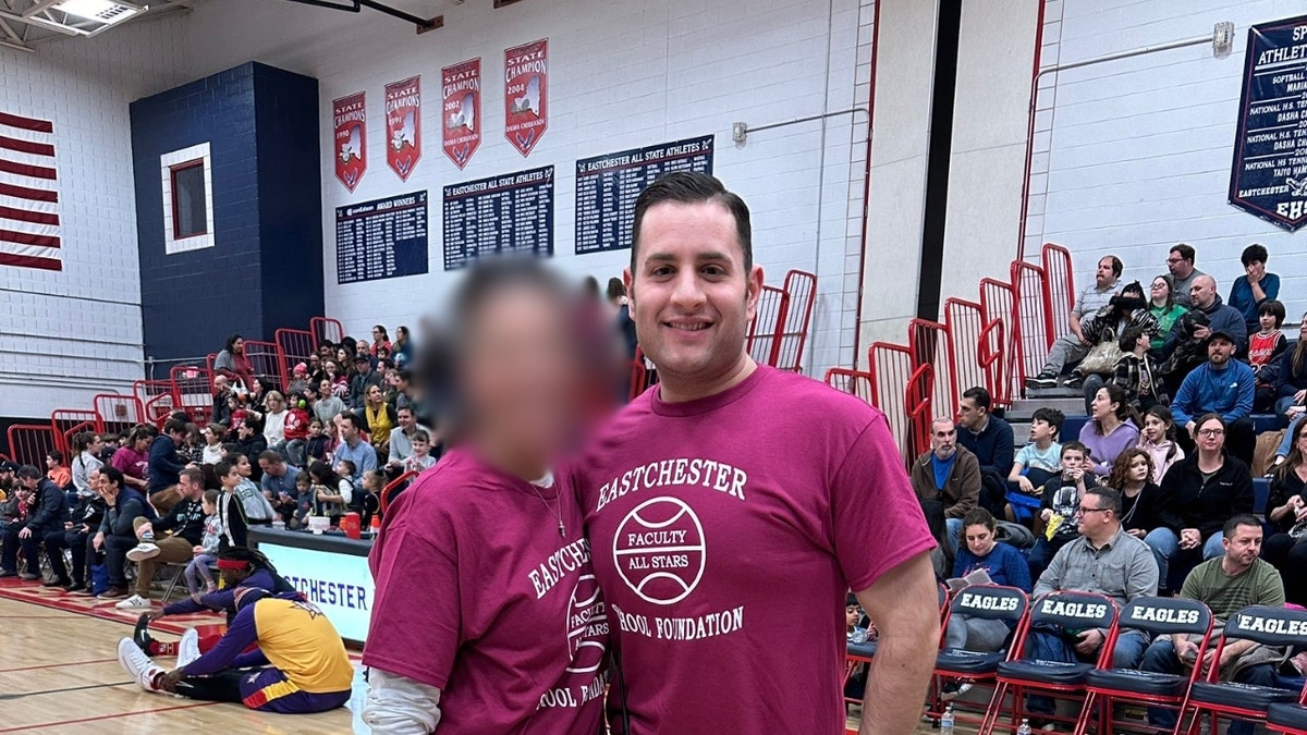 Thomas Puccini poses with a colleague in the Eastchester High School gymnasium