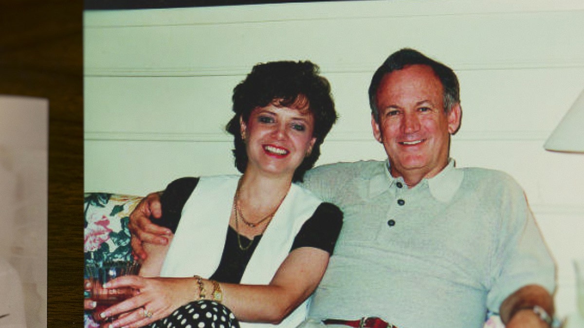 Patsy and John Ramsey sitting next to each other and smiling.