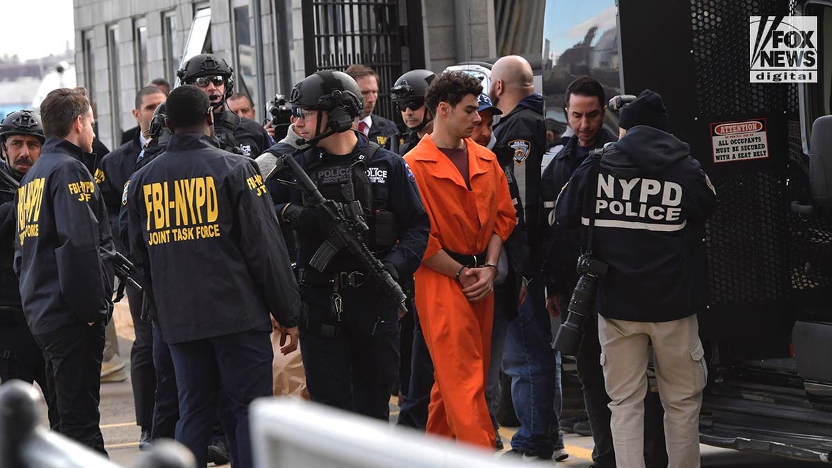 Luigi Mangione is escorted by NYPD into a van after being extradited from Pennsylvania for the murder of United Healthcare CEO, Brian Thompson.