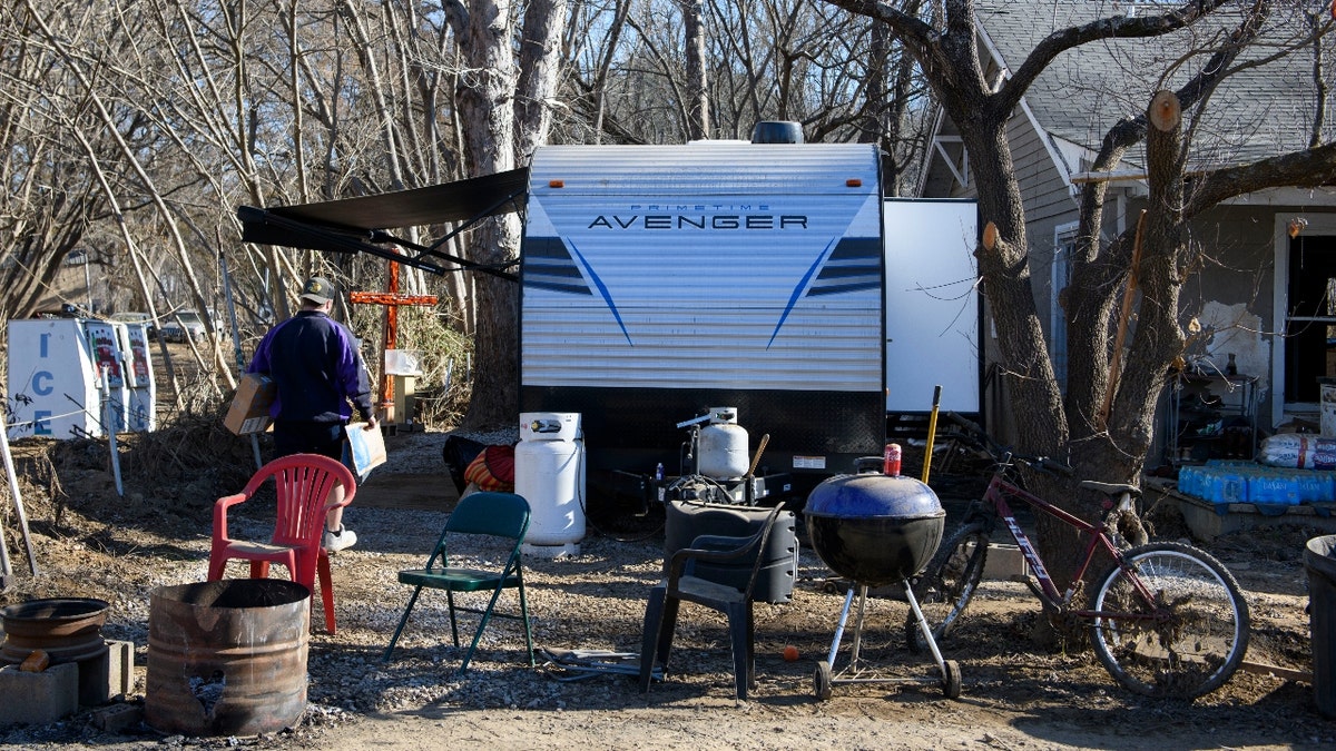 DECEMBER 23: A Fed Ex worker delivers packages to a trailer on December 23, 2024 in Old Fort, North Carolina. The trailer was given to the marine veteran from the Department of Veterans Affairs. 