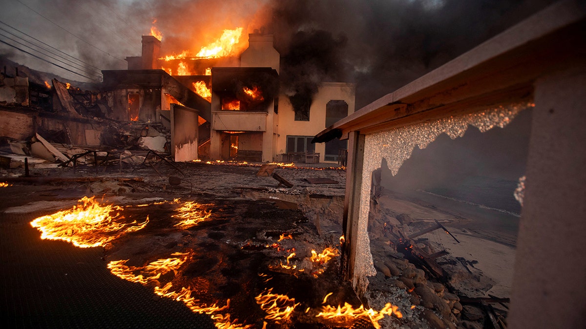 Palisades fire burns during a windstorm on the west side of Los Angeles