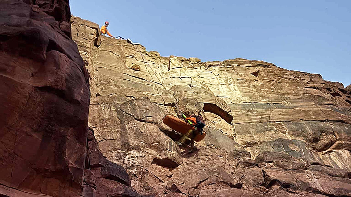 First responder rappels down side of Grand Canyon West while holding basket
