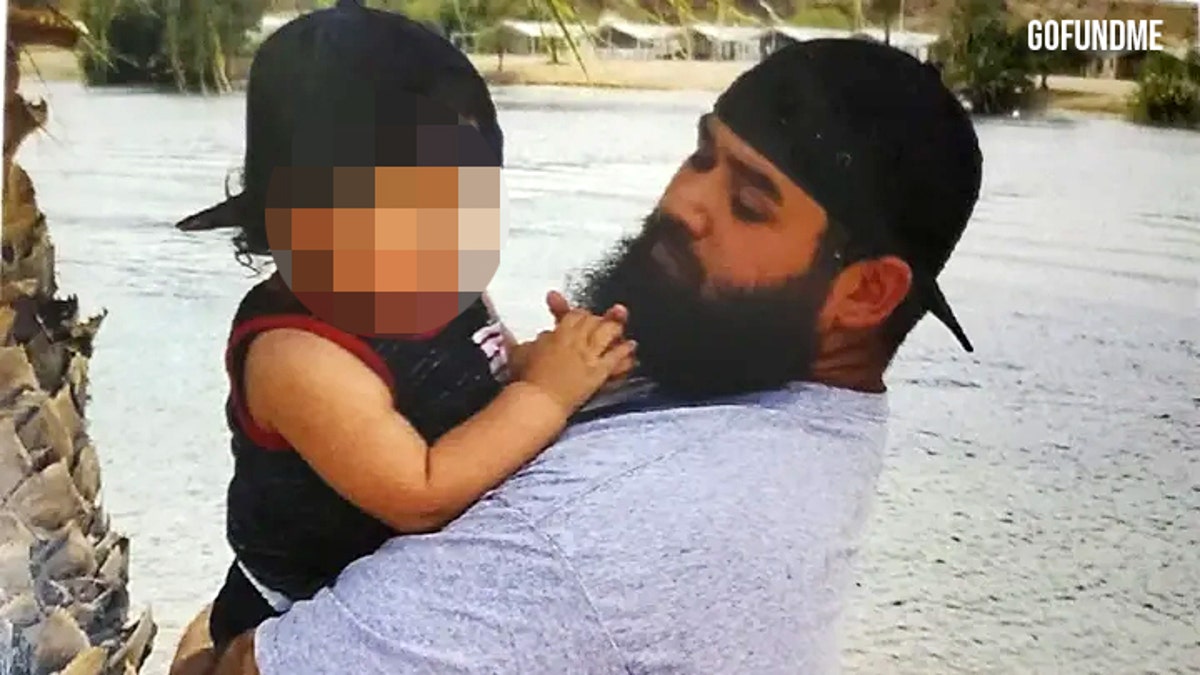 Michael Virgil holding a child