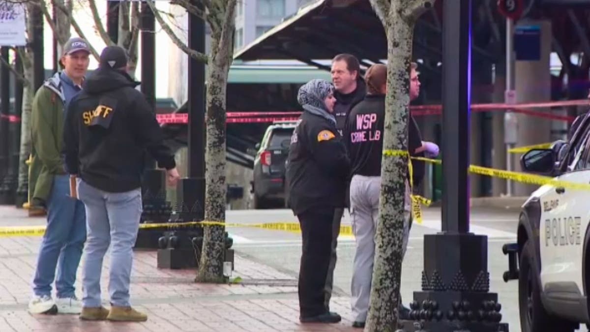 Investigators and police at Bellevue Transit Center crime scene