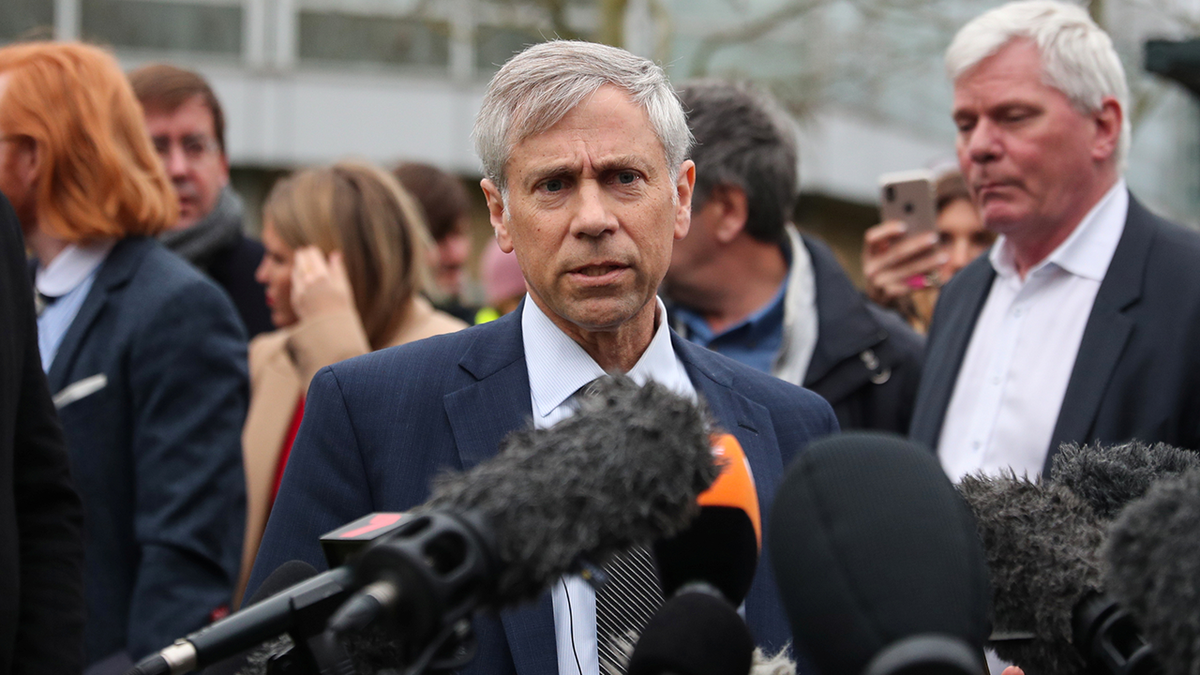 Barry Pollack, in a navy blue suit, speaks to reporters during a news briefing outside a London court