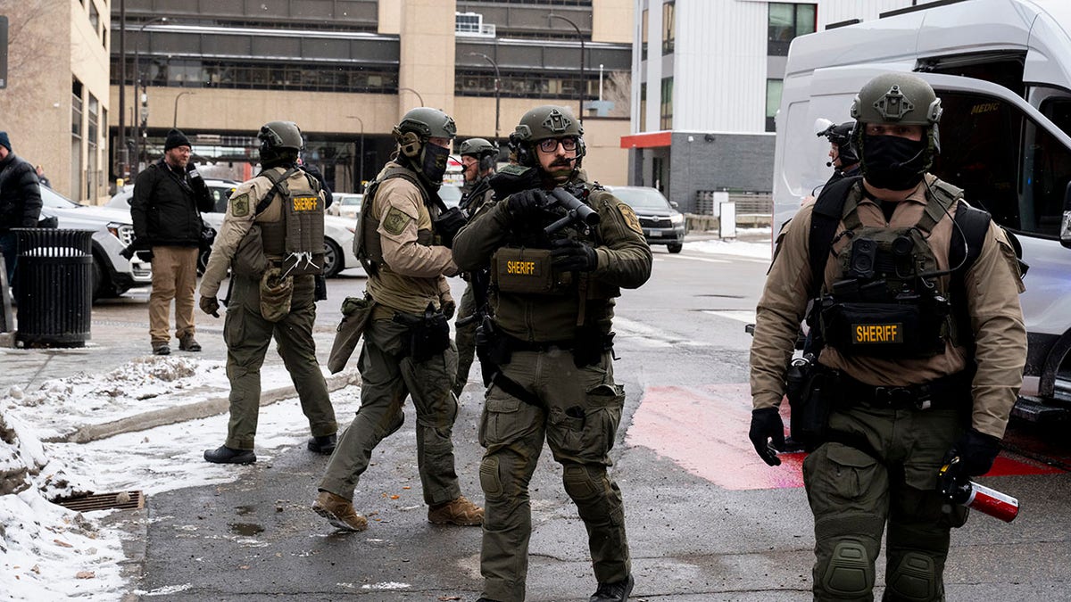 Local Minnesota authorities outside a courthouse