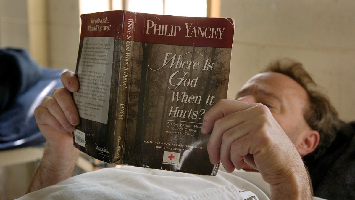 Man reads Philip Yancey book