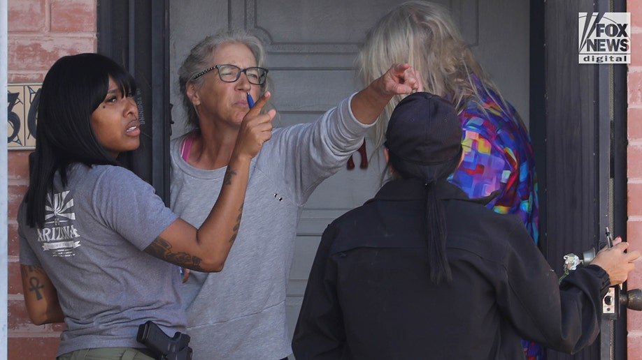 FBI investigators wearing tactical vests walking through Annie Guthrie's neighborhood in Tucson, Arizona