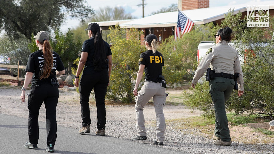 FBI investigators wearing tactical vests walking through Annie Guthrie's neighborhood in Tucson, Arizona