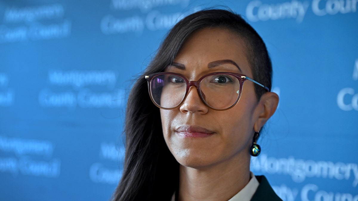 Kristin Mink wearing glasses and smiling