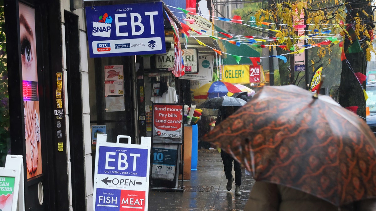 An EBT sign is displayed on the window of a grocery store