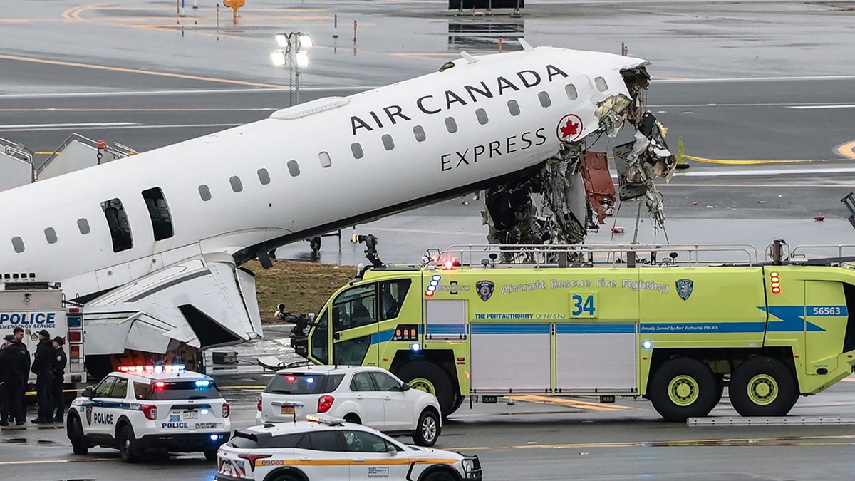 An Air Canada Express CRJ-900 airplane sitting on a runway at LaGuardia Airport after a collision.