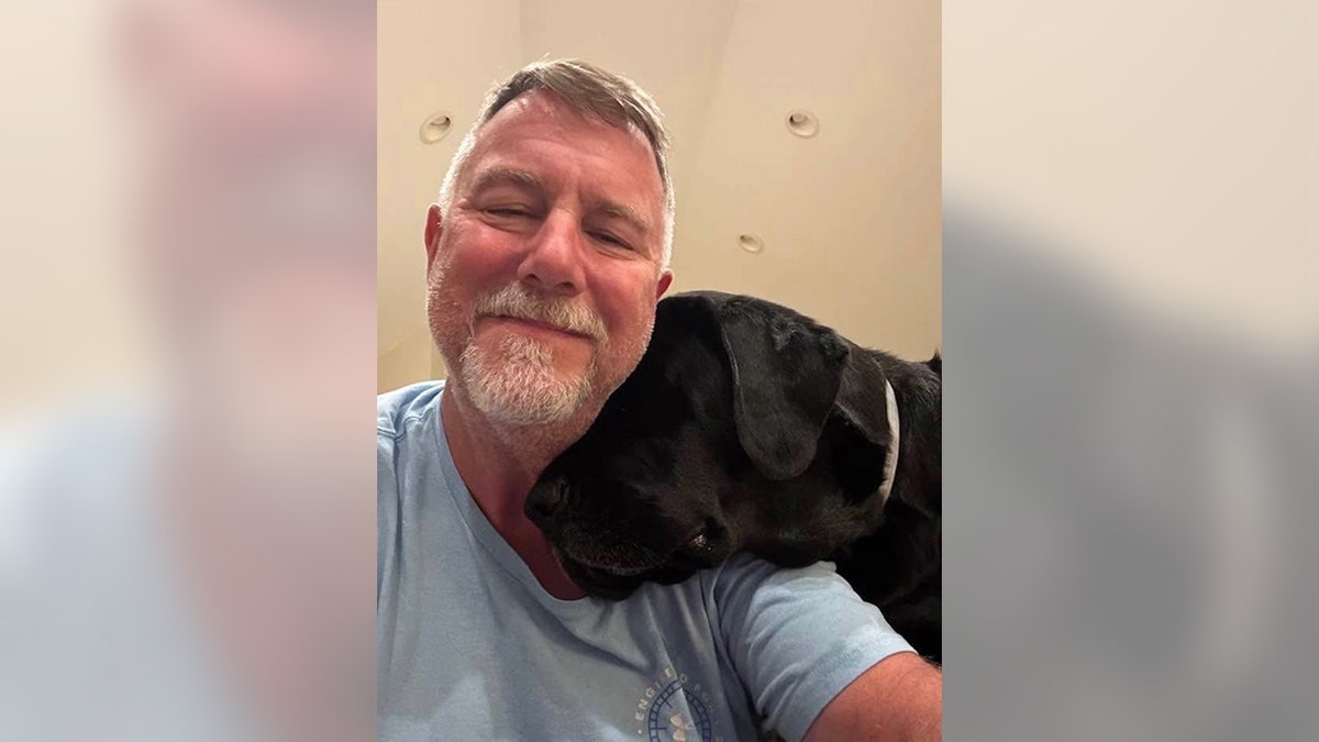 Christopher Badcock pictured with a dog