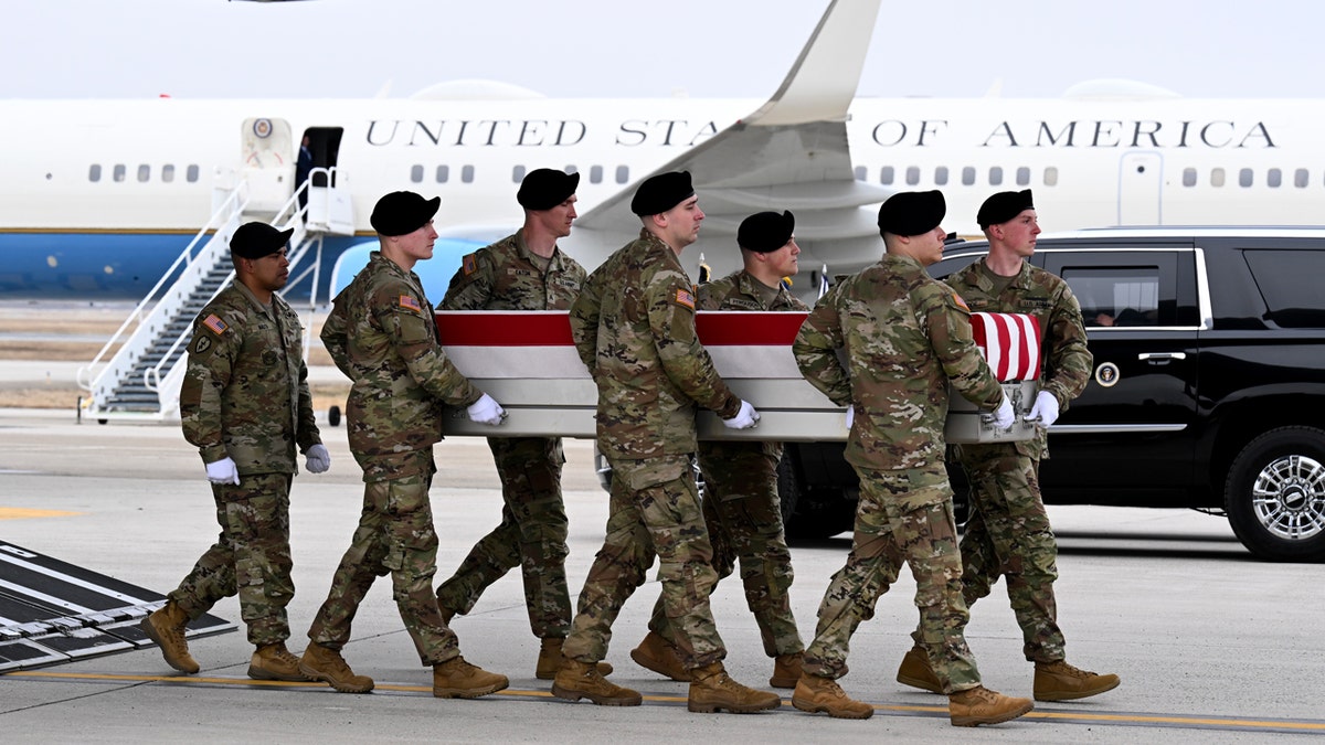Soldiers carry casket of fallen soldier during Dignified Transfer