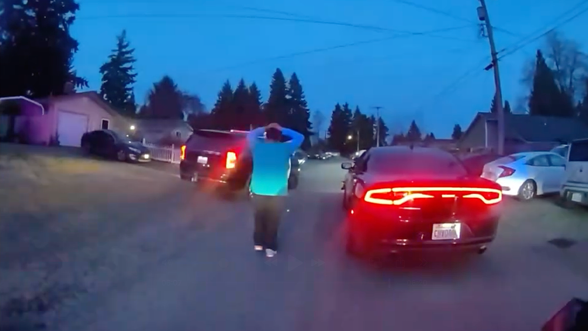 Suspect walks with hands on head between vehicles after fleeing 100 mph police chase