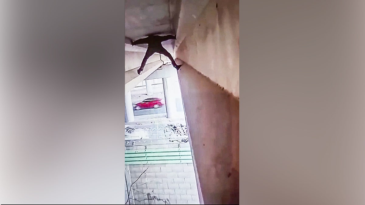 Illegal immigrant climbing under an overpass.