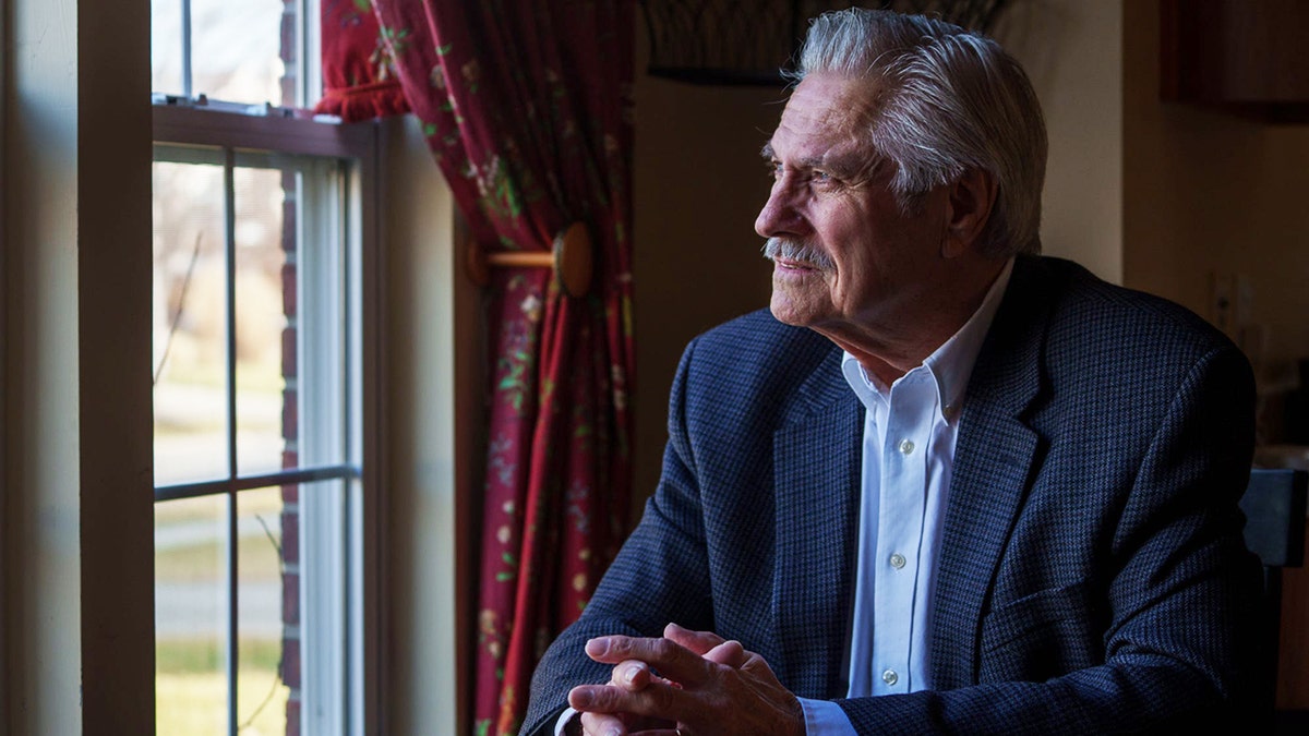 Larry Sells looking out the window.