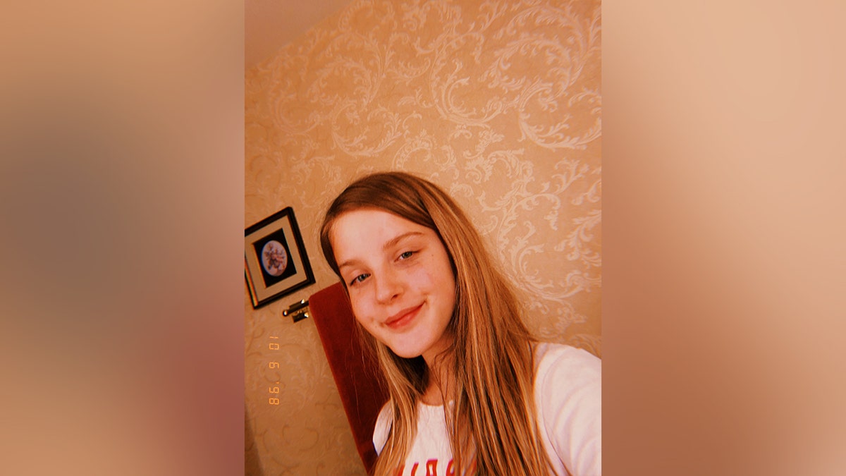 Lilly bova selfie in white t-shirt with wall in background