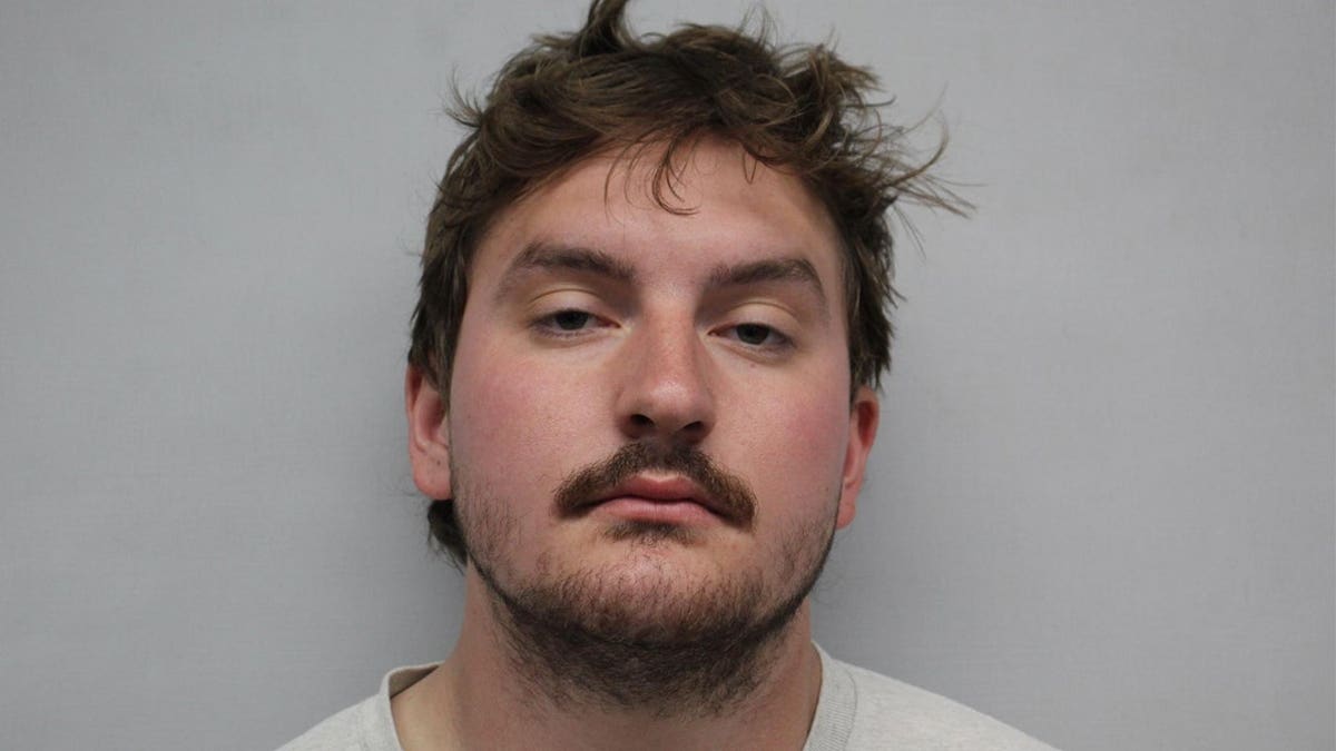 Peyton Beam emotionless in a booking picture