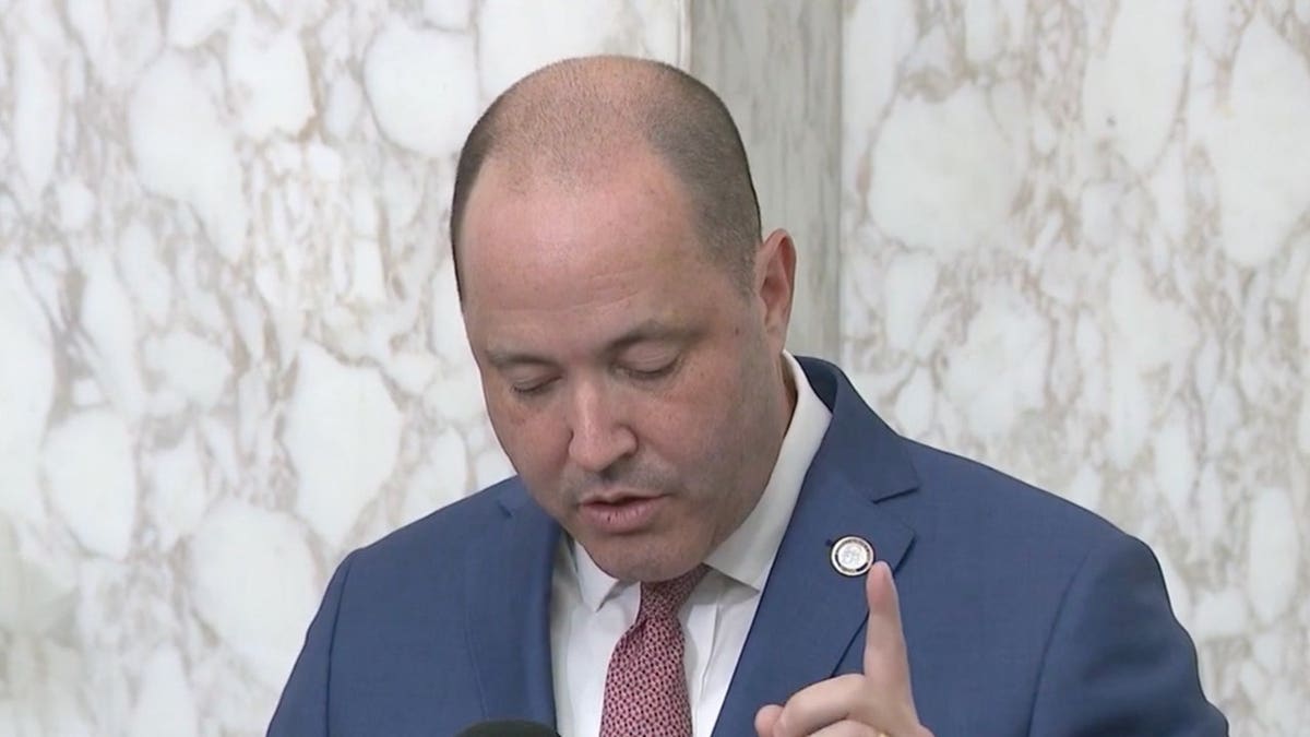 Georgia Attorney General Chris Carr holds his finger up during a press conference