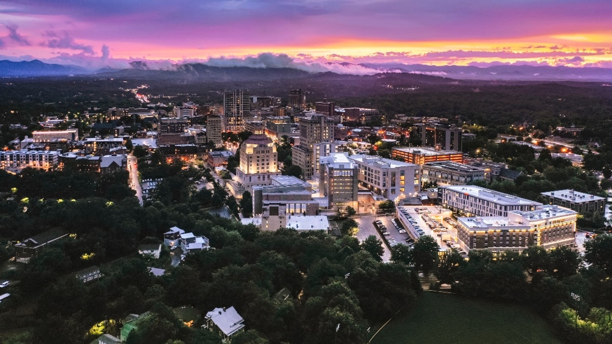 Asheville North Carolina skyline at sunset with mountains in background