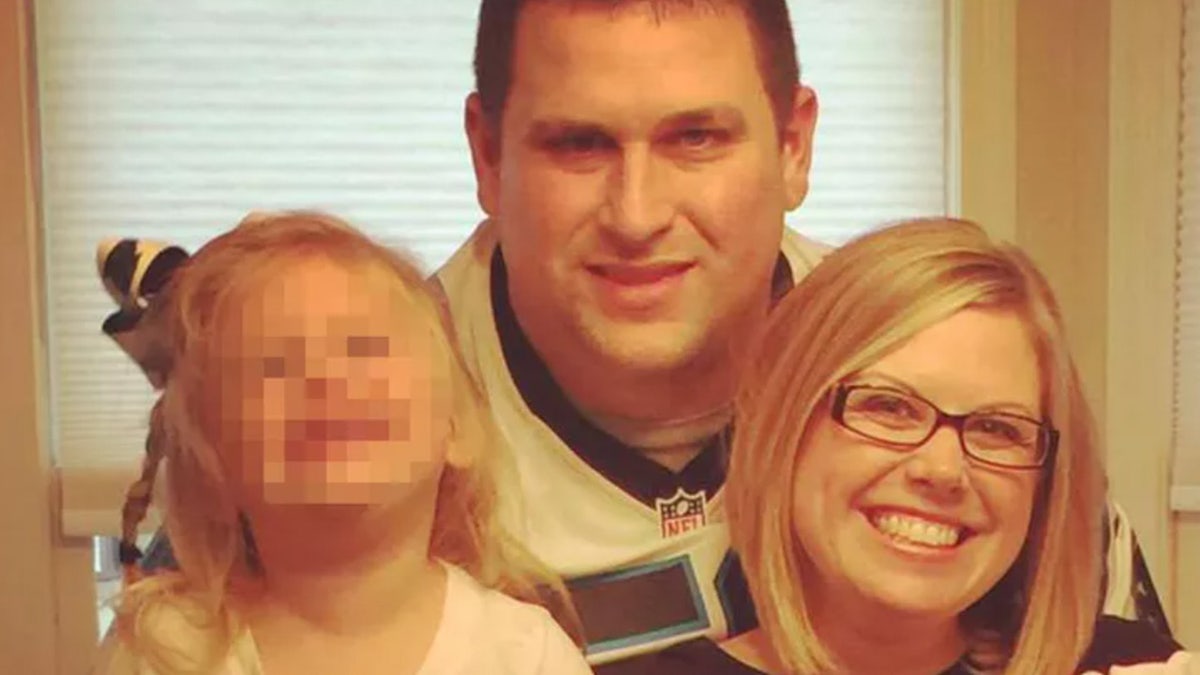 Joshua Hunsucker and Stacy Hunsucker with their young daughter in an undated photo