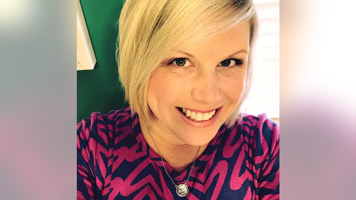 Stacy Hunsucker wearing a pink and black blouse