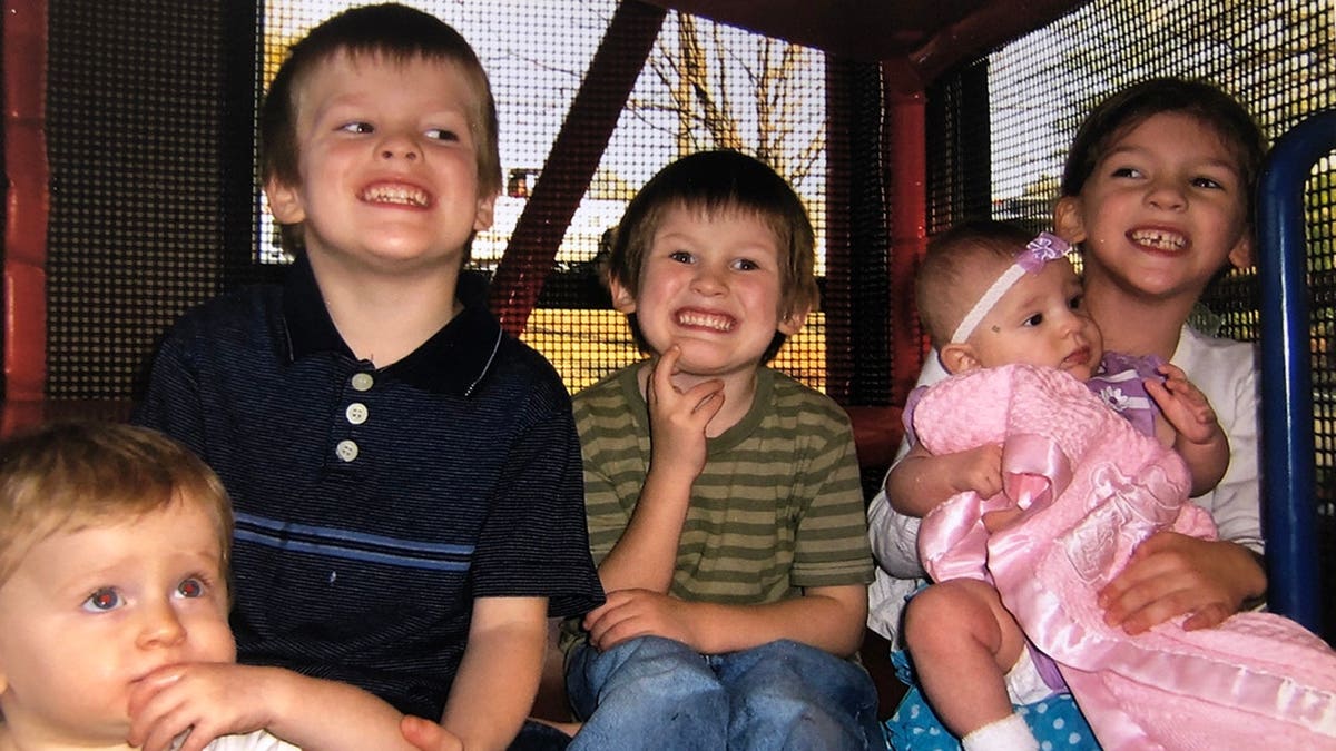 Timothy Jones Jr.'s children smiling in a playground.