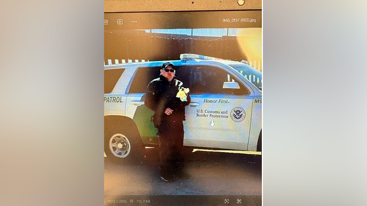 Alvarez-Gonzalez posing in front of a Border Patrol vehicle in photo cited by DOJ