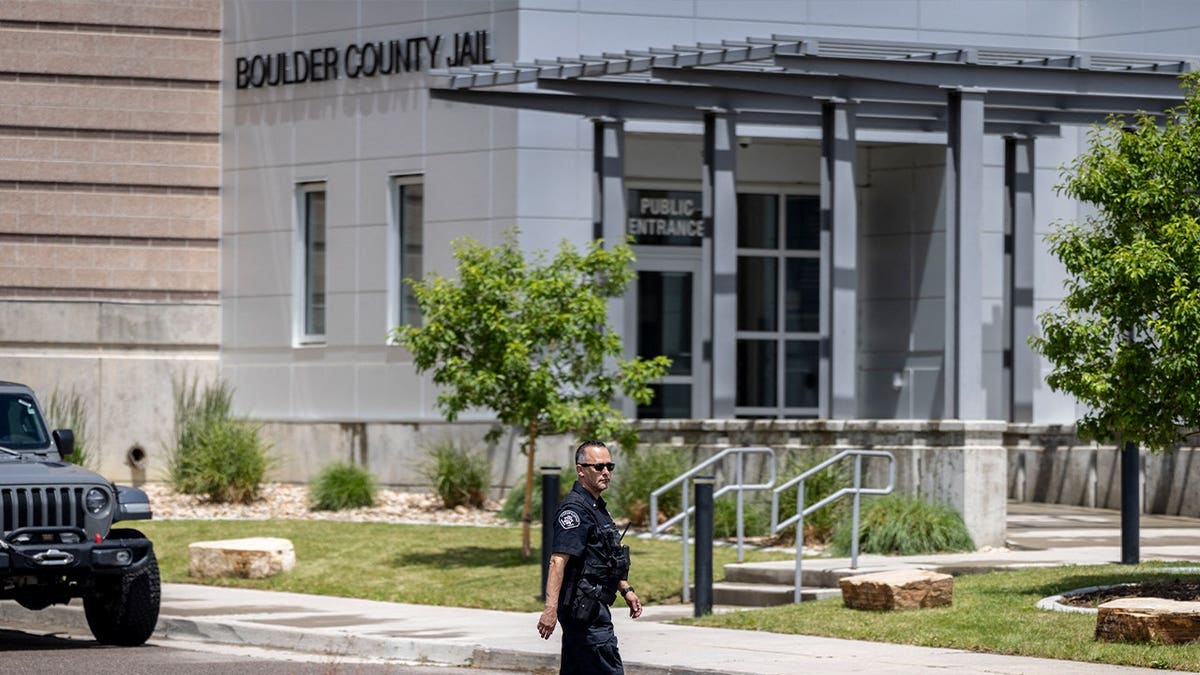 officer walks on street outside boulder county jail