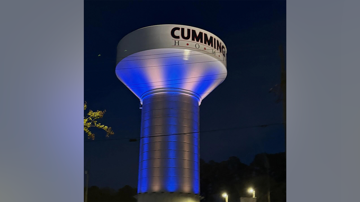 Cumming water tower lit in blue and gold honoring students killed in Florida crash