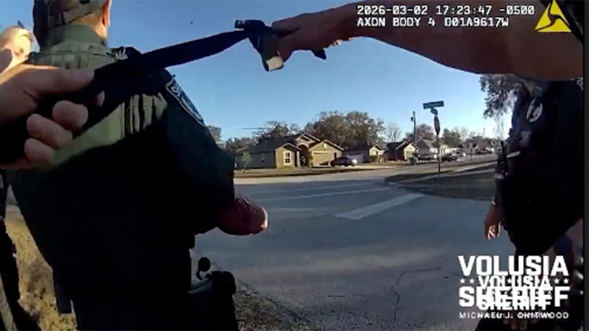 Deputy Jose Rivera receiving a tourniquet from police in Volusia County