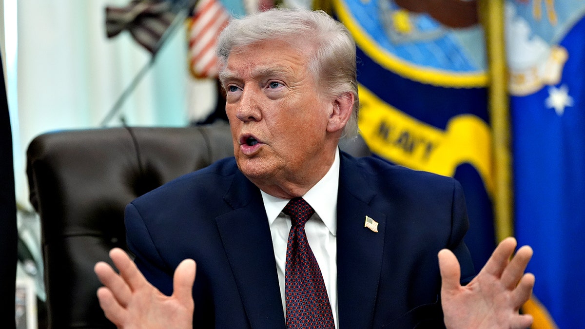 President Donald Trump gesturing while speaking in the Oval Office