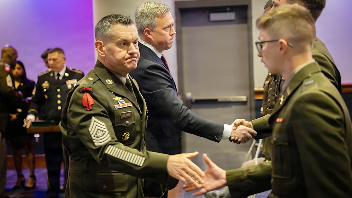 Army Secretary Dan Driscoll and Sergeant Major Michael R. Weimer shaking hands during a ceremony