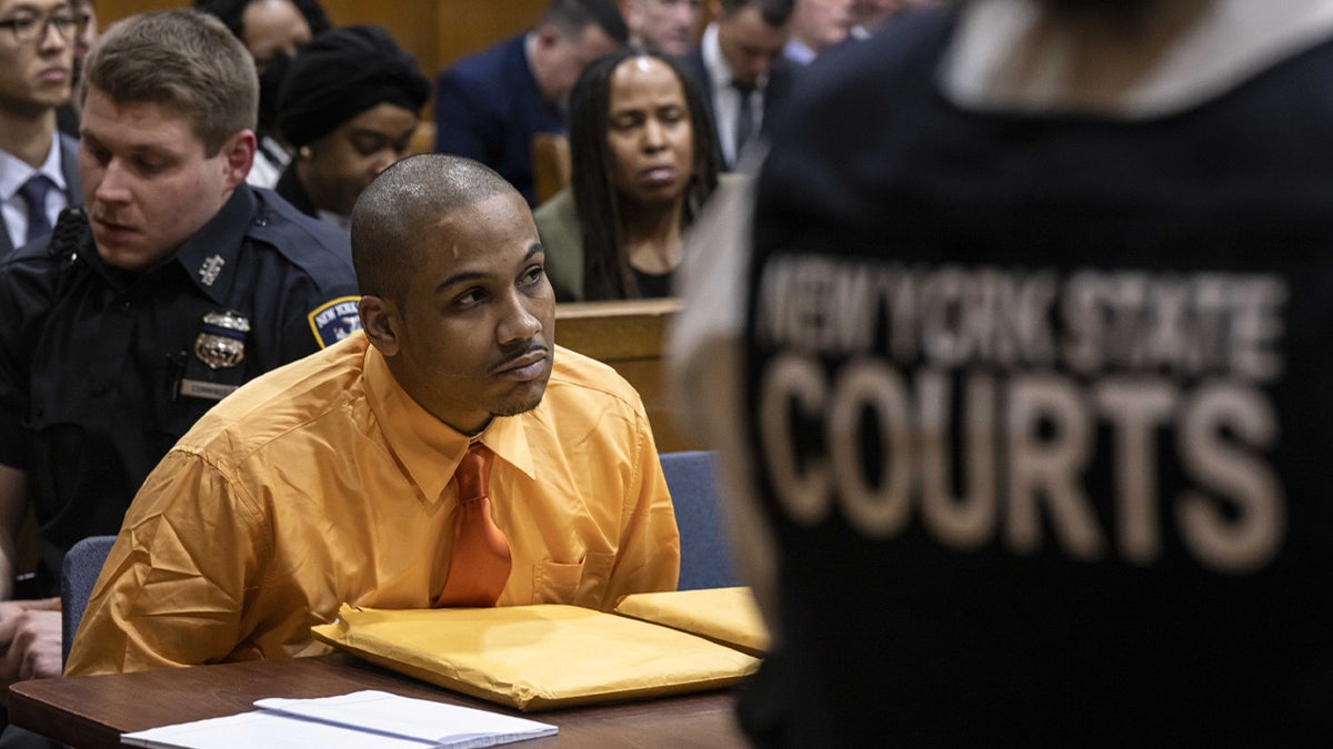 Guy Rivera wearing yellow shirt in court