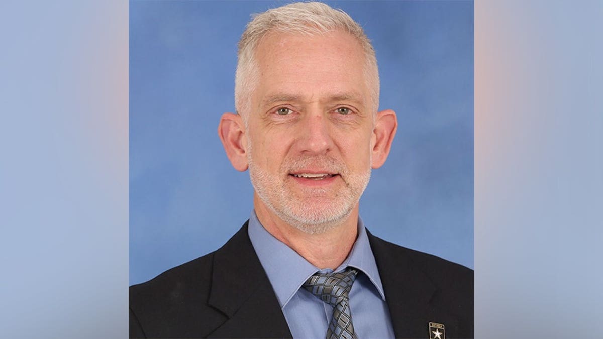 James Tony Moffatt standing and smiling in a NASA uniform