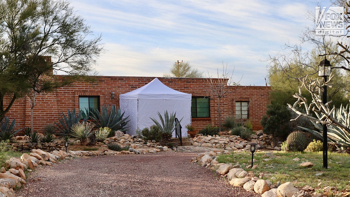Forensic investigators arriving at Nancy Guthrie's home with a tent over the front entrance in Tucson, Arizona