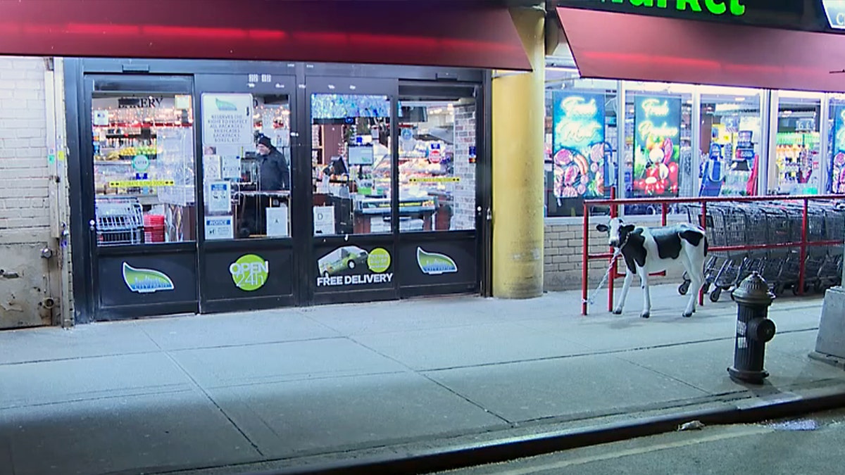 NYPD officers standing outside a store exterior