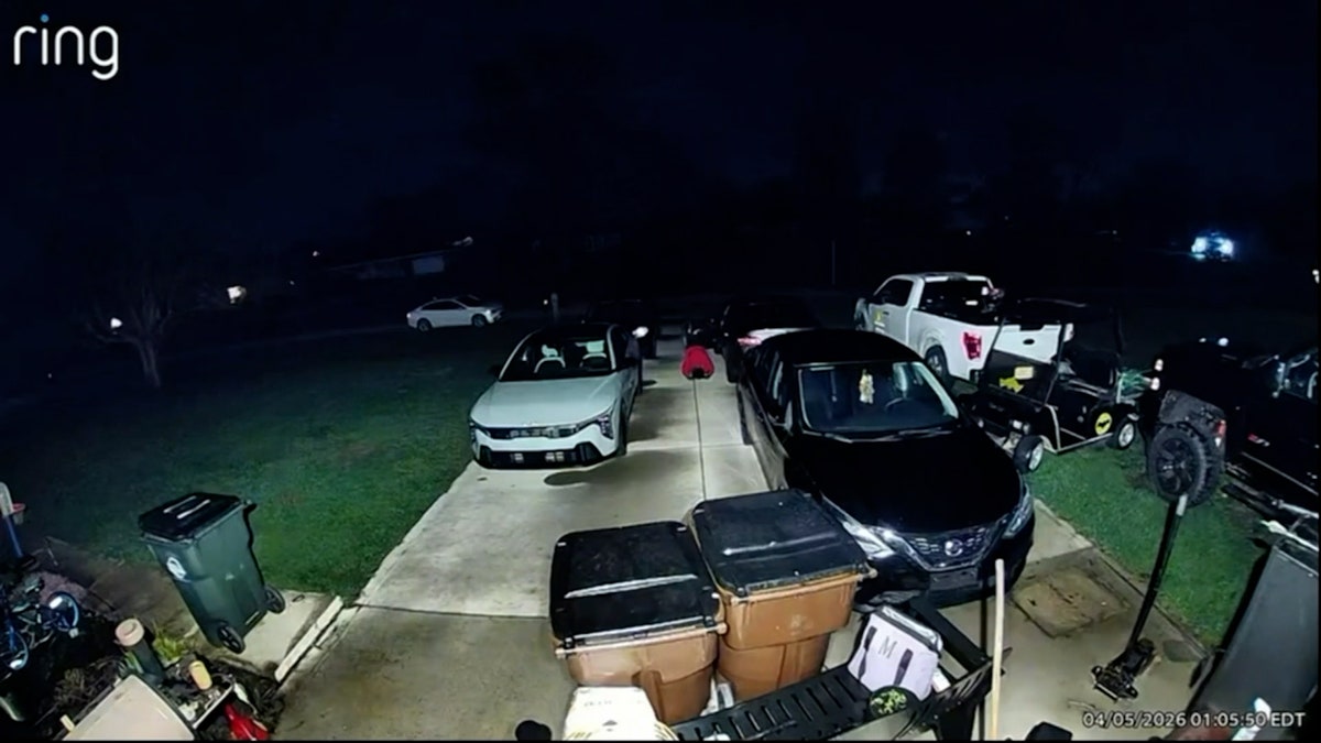 a man prays in a driveway