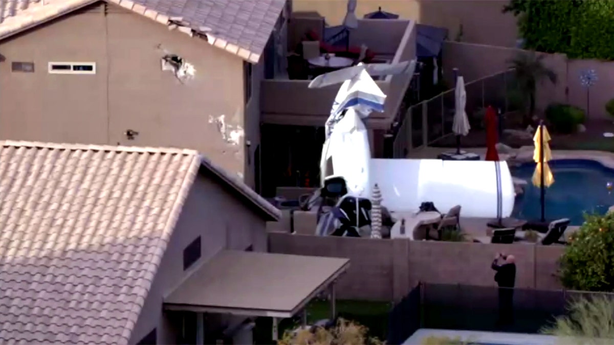 small plane wreckage in residential backyard