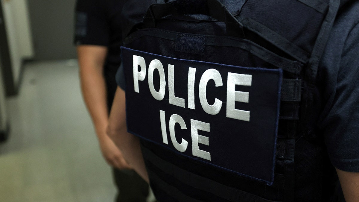 FILE - ICE agent standing in hallway outside courtroom at New York Federal Plaza Immigration Court