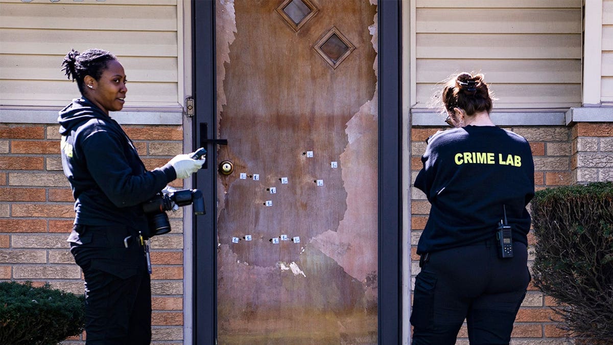 Investigators examine bullet holes in front door of Indianapolis councilor Ron Gibson’s home